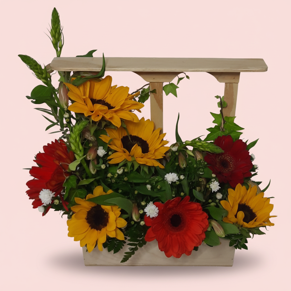 Arreglo floral con girasoles y gerberas en ventana de madera artesanal